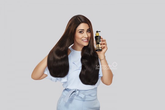 Actress Shriya Saran posing for Hair Tonic product.